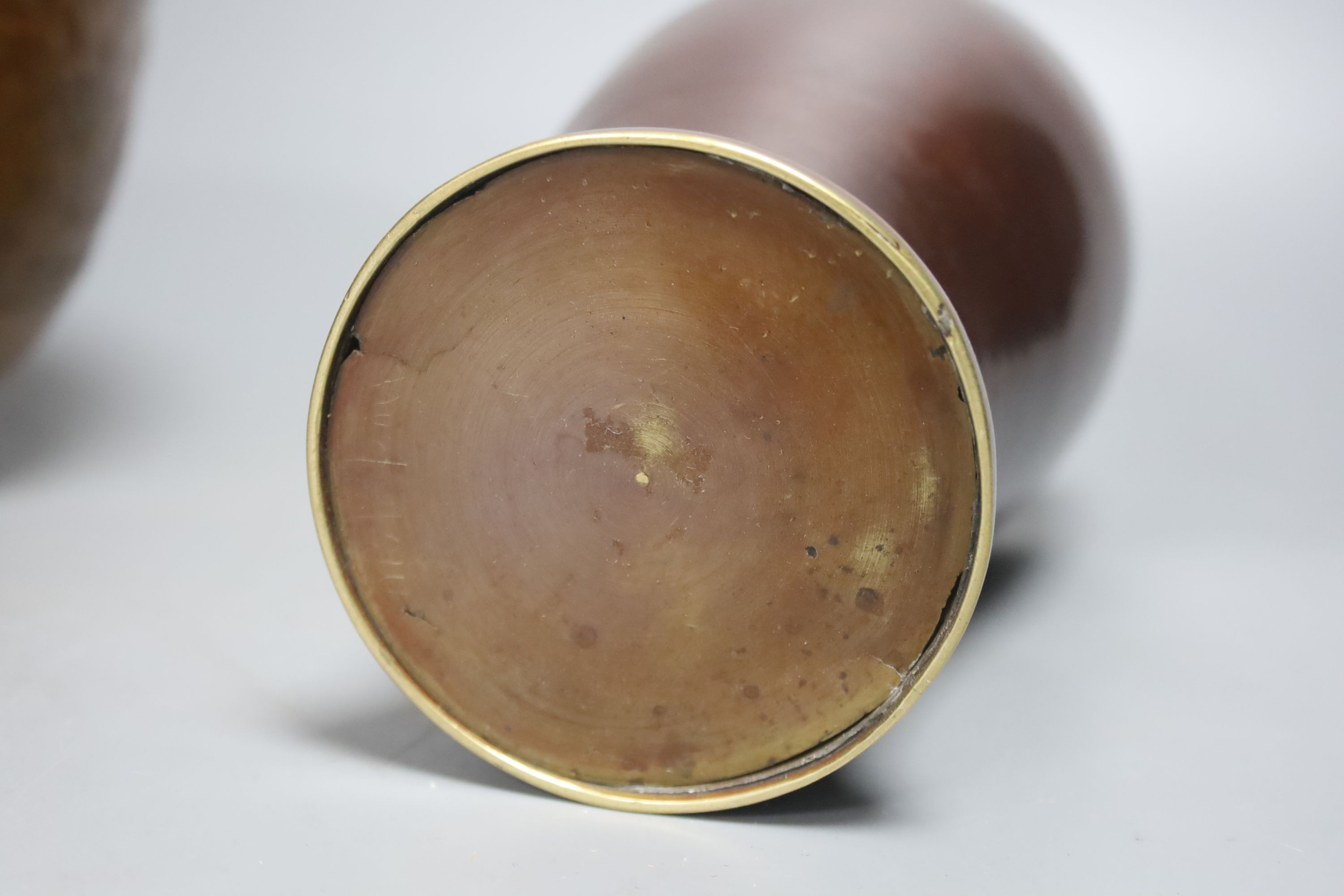 A Japanese bronze 'Daruma' vase and a pair of bronzed aluminium tripod bowls, vase 25 cms high.